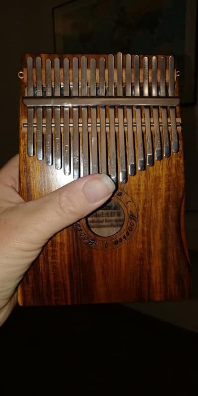 Thumb shown across a moozica thumbs piano for size comparison